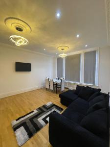 a living room with a couch and a table at Luxury Apartment with a jacuzzi in Wolverhampton
