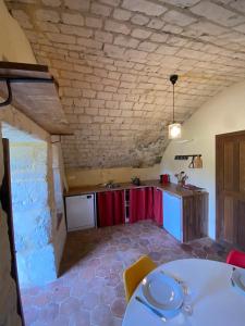 a room with a table and a kitchen in a building at Tour du manoir de Boiscorde in Rémalard
