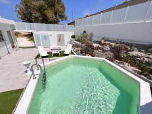 a swimming pool in the backyard of a house at villa Dantès in Bari