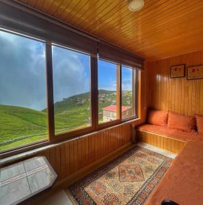 an empty room with a large window with a view at Karester Villa Apart in Uzungöl