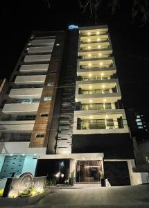 a tall building at night with lights on at Apartamentos Santa Gema in Medellín
