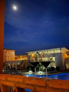 two glasses of wine sitting on a fence at night at Apartamento Punta Umbría Parking Incluido y Piscina in Punta Umbría