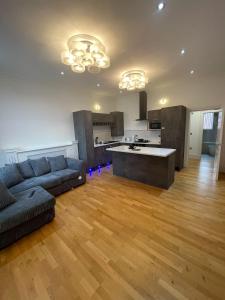 a living room with a couch and a kitchen at Luxury Apartment APT5 in Wolverhampton