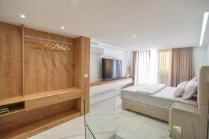 a bedroom with a bed and a television at Misisuone Apartments Budva in Budva