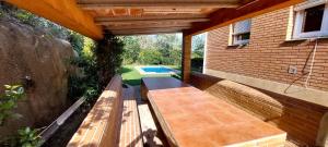 a patio with a bench and a swimming pool at Bravaholidays-601-Lloret Park 1 in Vidreres
