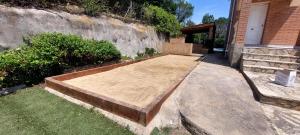 a wooden bed sitting outside of a house at Bravaholidays-601-Lloret Park 1 in Vidreres +40 photos
