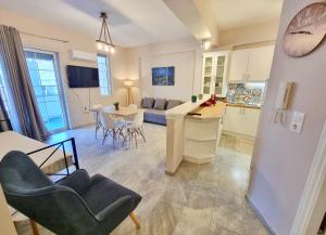 a kitchen and living room with a table and chairs at Gemareia Lodge in Lefkada