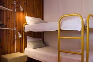 a room with three bunk beds and a chair at Douro Charming Chalet in Melres