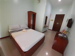 a bedroom with a bed and a television in it at Westville Tourist Inn in Puerto Princesa City