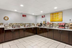 a large kitchen with a counter with food on it at Best Western Plus Jonesboro Inn & Suites in Jonesboro