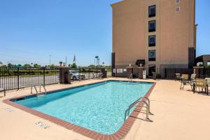 a large swimming pool in front of a building at Best Western Plus Jonesboro Inn & Suites in Jonesboro