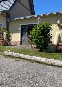 a house with a porch with a table and chairs at Las Fincas Baabe in Baabe