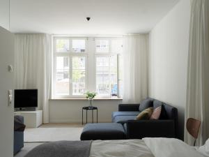 a living room with a couch and a tv at KAJO269 FERIENcc WOHNUNGEN IN DER ALTSTADT in Freiburg im Breisgau
