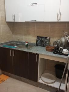 a kitchen counter with a sink and a toilet at Appart ElCampo in Tangier