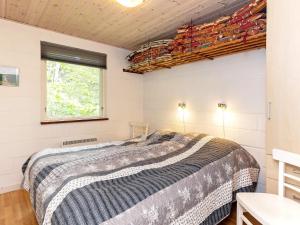 a bedroom with a large bed and a window at Two-Bedroom Holiday home in Thyholm 4 in Sindrup