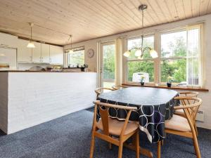 a kitchen and dining room with a table and chairs at Two-Bedroom Holiday home in Thyholm 4 in Sindrup