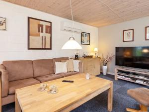 a living room with a couch and a coffee table at Two-Bedroom Holiday home in Thyholm 4 in Sindrup