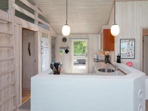a kitchen with a large white island in a room at 7 person holiday home in Løgstør-By Traum in Løgsted +26 photos
