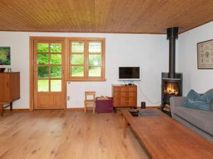 a living room with a couch and a fireplace at Holiday home Aars II in Års