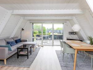 a living room with a couch and a table at Holiday home Farsø XXIII in Farsø