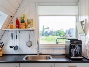 a kitchen with a sink and a window at Golf & Spa Retreat - By Traum Ferienwohnungen in Farsø