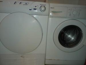 a washing machine sitting next to a dryer at Soufis house in Igoumenitsa