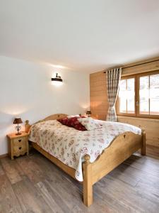 a bedroom with a wooden bed and a window at Hotel Les Mélèzes in Haudères +37 photos