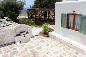 a white building with a pizza oven in a yard at Aegean traditional home in Athens Riviera in Sounio