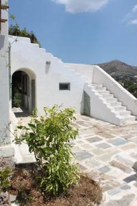 a white house with a staircase and a plant at Aegean traditional home in Athens Riviera in Sounio
