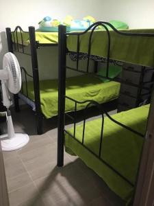 a room with two bunk beds with a fan at PEÑALISA in Ricaurte