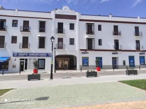 a white building with a street light in front of it at Paseo Imperial in Arcos de la Frontera