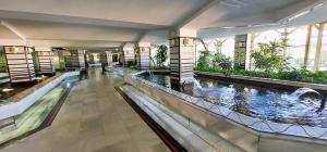 a hotel lobby with two pools and a water slide at Benal Beach Vibe in Benalmádena