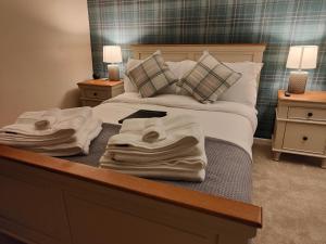 a bedroom with a bed with towels on it at Ystafell Gelert Room in Beddgelert