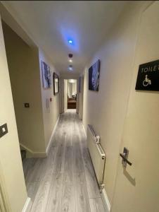 a long hallway with a toilet sign on a wall at Modern Appartment in London