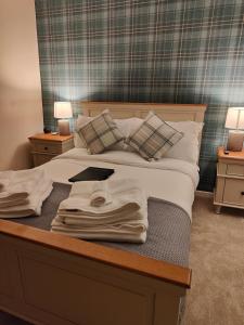 a bedroom with a bed with a laptop on it at Ystafell Gelert Room in Beddgelert