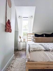 a bedroom with a bed and a window at Scandi Inspired 2 Bed Suite Sandbanks Pass Incl in Picton