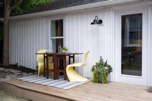 a table and chairs sitting on a deck at Scandi Inspired 2 Bed Suite Sandbanks Pass Incl in Picton