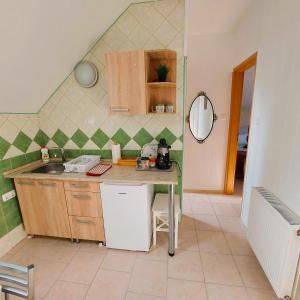 a kitchen with a sink and a counter top at Jókai Vendégház in Egerszalók