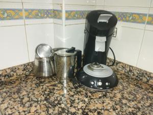 a kitchen counter with a coffee maker and a blender at Adosado con Patio Punta Umbria in Punta Umbría