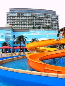 a pool with a water slide in front of a hotel at Sun Valley Hotel in Yeoju
