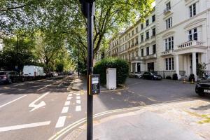 a street sign on a pole in the middle of a street at Paddington House in London