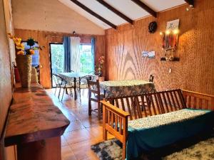 a living room with two tables and two benches at marari rapa nui in Hanga Roa