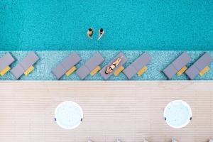 an overhead view of a pool with people in the water at Garden Terrace Nagasaki Hotel & Resort in Nagasaki