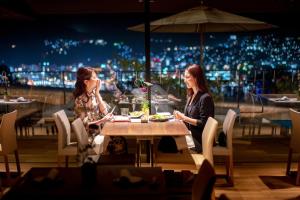 two women sitting at a table in a restaurant at Garden Terrace Nagasaki Hotels & Resorts in Nagasaki +176 photos