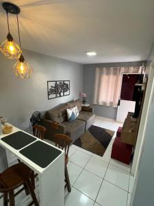 a living room with a couch and a table at Apartamento Mobiliado em Petrolina - Recomendado! in Petrolina
