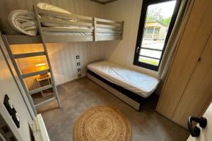 a small room with a bunk bed and a ladder at Cottage - 40 m all comfort with garden in Guérande
