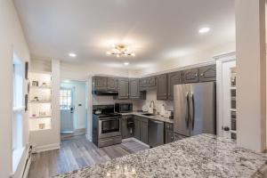 a kitchen with gray cabinets and stainless steel appliances at Luxurious Retreat, Parking, Restaurants, Near New Hope, 1mile Delaware River in Lambertville