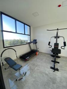 a gym with two exercise bikes and a window at Departamento de lujo tipo dúplex in Ciudad del Este