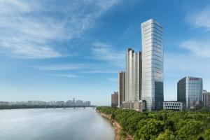 een weergave van een hoog gebouw naast een rivier bij Grand Hyatt Changsha-Close to Helong Sports Center in Changsha