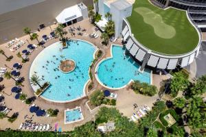 an overhead view of two pools in a resort at Beautiful Panama City Beach Condo- Ocean View! in Panama City Beach